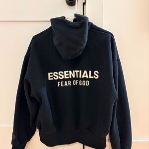 Fear of God ESSENTIALS Black Hoodie with White Tag Detail